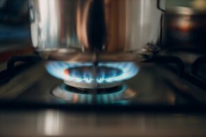 Burning gas flame on a kitchen gas stove pan.